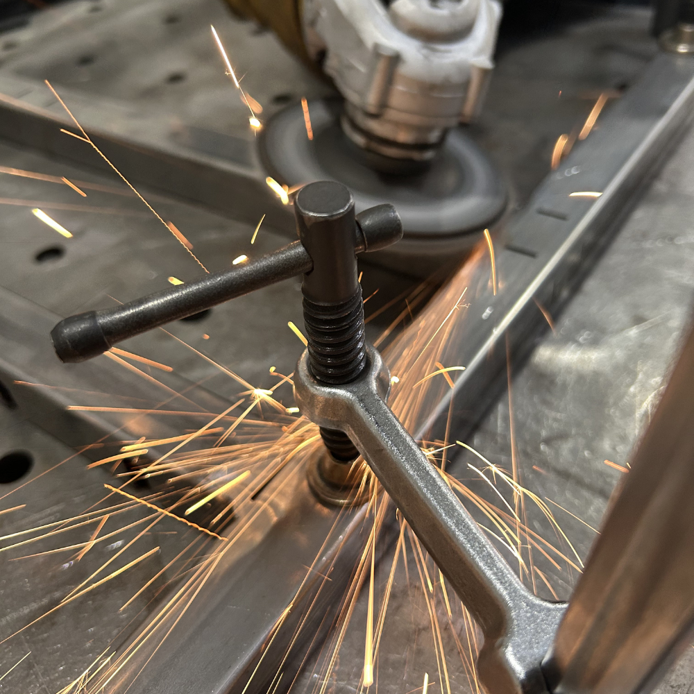 Close-up of grinding welds with sparks flying during DIY welding cart build